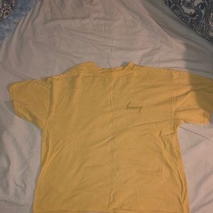 A brandy Melville honey t-shirt. Never been worn.